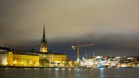 Time Lapse of Stockholm Riddarholmen and construction crane at night. Capital of Sweden cityscape