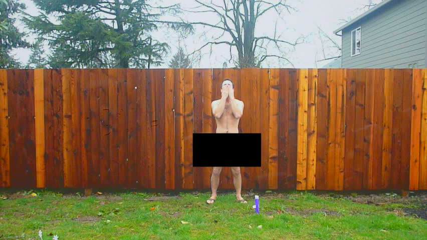 Naked man with censor bar walks into frame and showers in rainstorm