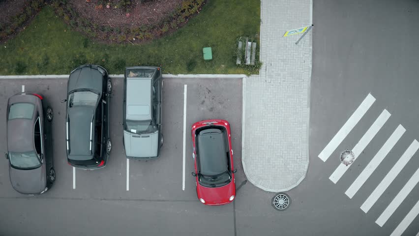 Saint-Petersburg, Russia - october 20, 2016 Upcoming passenger car occupy only free parking place at outdoor parking slot near shopping or business center in the early morning. Top aerial shot