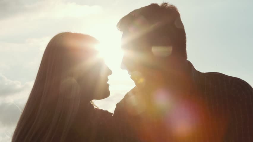 Few shots of young couple darken silhouette kissing and smiling on a bright sunlight. Love story. Being happy together. Happy moments. Outside shooting, sun lens. | Shutterstock HD Video #23390452