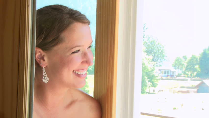 Model released bride getting ready early on her wedding day, smiling while