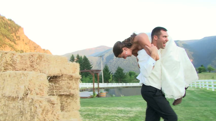 Groom carries his Bride in celebration on their wedding day.