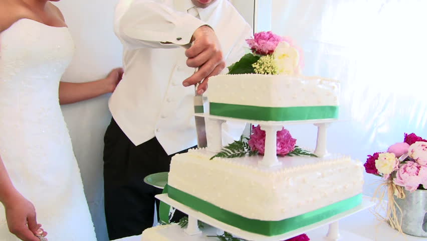 Model released bride and groom cut their cake on their wedding day.