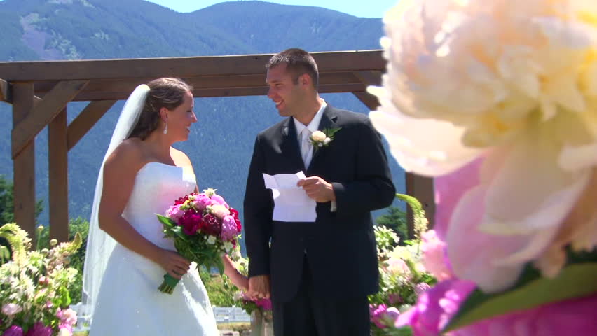 Model released bride and groom reading vows then kiss on their wedding day at