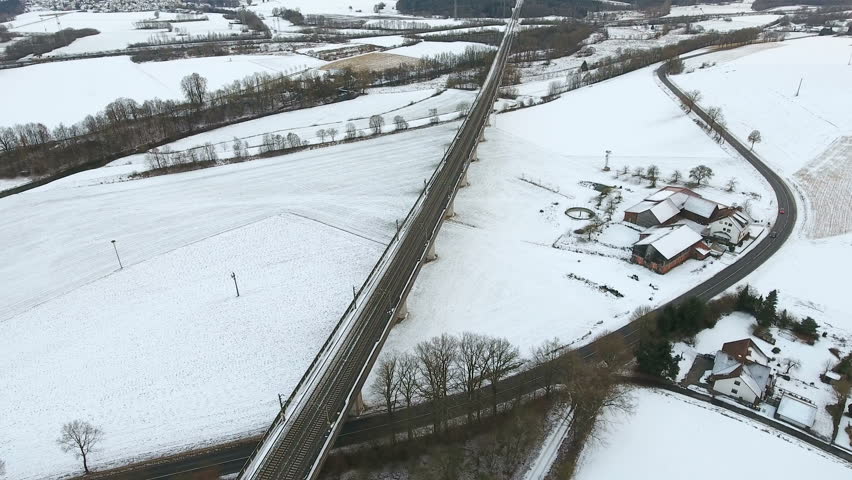Railroad track through wintery countryside