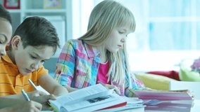 Children doing homework together at home or at homework club