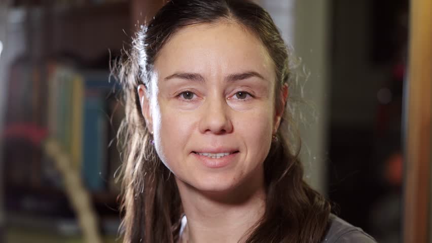 Close-up portrait of young cute European girl smiling at the camera.