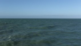 View of waves on the sea, Normandy. Azure water background. Waves pattern. Vacation in north of France. Action. Real time video, day.