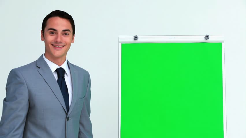 Businessman giving a presentation on a board in studio