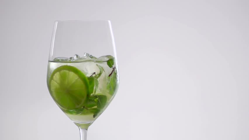 SLOW MOTION CLOSE UP: mint drops in a glass of drink Hugo Royalty-Free Stock Footage #23414896