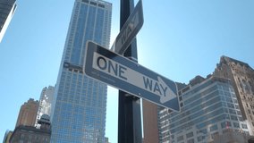 CLOSE UP, LOW ANGLE VIEW: New York City navigation indicating direction: one way road signboards fixed on a pole at traffic intersection in the downtown business district of Lower Manhattan, USA - Powered by Shutterstock - Get 15% off with code: PIKWIZARD15