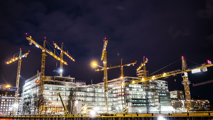 Construction site at night Time Lapse. Working tower cranes, buildings and traffic Royalty-Free Stock Footage #23419333