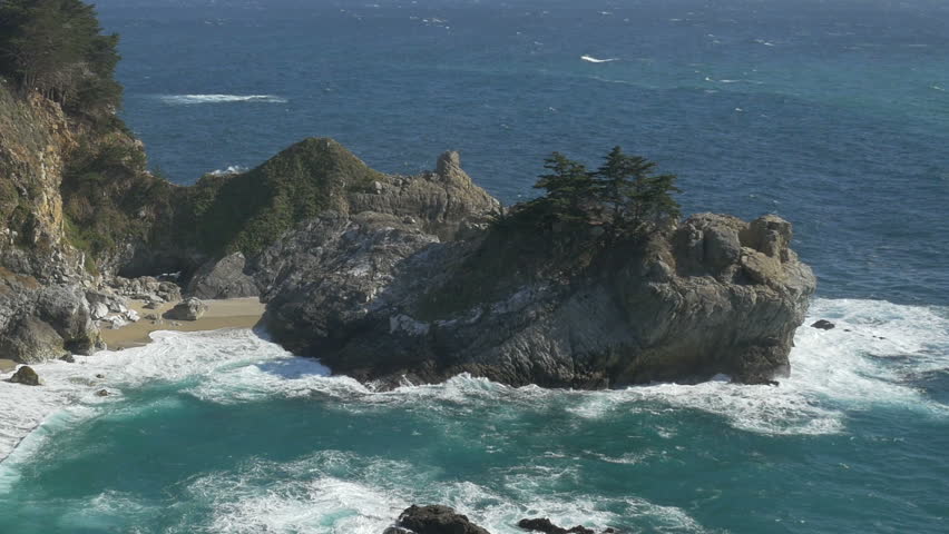Panning and zooming out view of McWay Falls in the Big Sur area of Central California. 