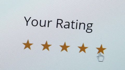 Close up shot of a computer screen with an online rating and review survey feedback poll getting an excellent five star review by the customer.