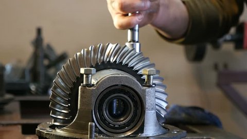 Mechanic repairing  vehicle reducer, close-up  