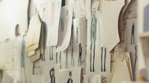 Zoom In On a Wall with Pinned Fashion Drawings and Sketches, Templates Hanging on the Wall. Shot on RED EPIC 4K (UHD).