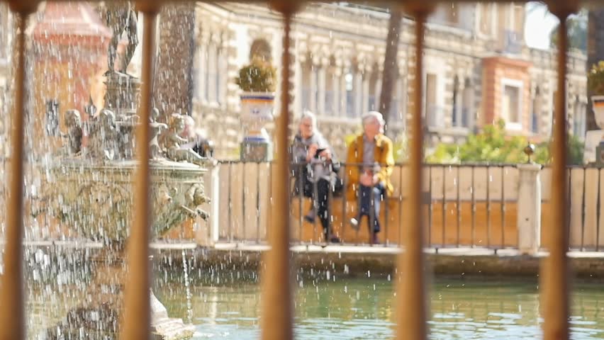 Traveling old couple relaxing on a bench in warm sunny weather