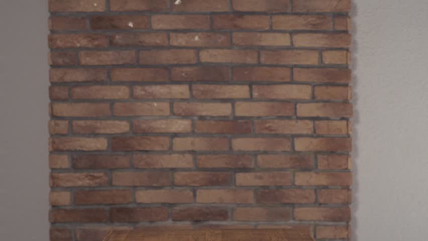 Smiling cute schoolboy walking along brick wall at the table with writing on flip chart start up.