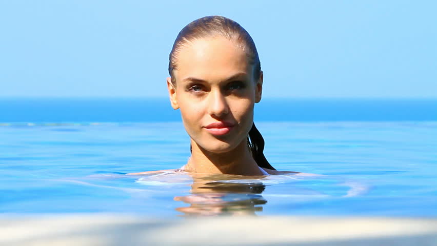 Lovely girl spending time in exotic swimming pool


