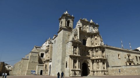 Mexico, Oaxaca-January 26, 2017: Cathedral of Soledad in Oaxaca, Time Lapse of the square before the church,people enter the front door of the church and out of side door , background blue sky,