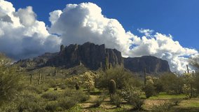 Arizona desert landscape with fluffy white clouds passing by.  Time-lapse