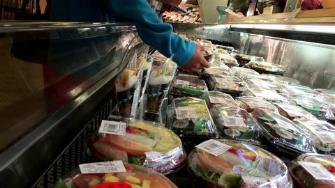 Burnaby, BC, Canada - September 06, 2016 : Motion of people buying sushi roll combo inside T&T supermarket with 4k resolution