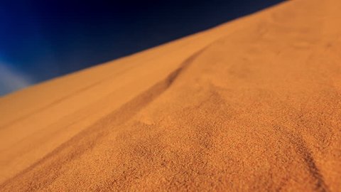 closeup camera moves along yellow quicksand in white sand dunes