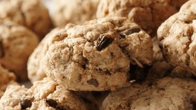 Close-up oatmeal homemade biscuits served on plate slow pan 4K 2160p 30fps UHD footage - Chocolate chip cookies on pile shallow DOF  3840X2160 UltraHD panning video