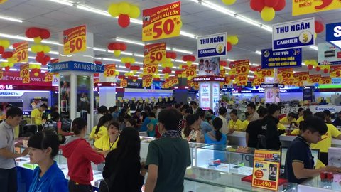VUNG TAU, VIETNAM - DECEMBER 10, 2016: A lot of people buy goods in Cho Lon electronics store on its opening day.