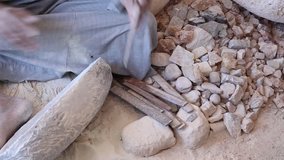 Close up of handcraft production of stone goods.  Anonymous worker cutting something from stone material. Egypt traditions. Real time full hd video footage.