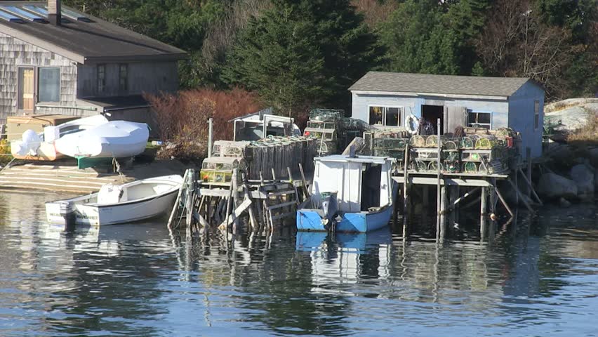 Waterfront fishing shack in Prospect Bay, Nova Scotia.  Early November, two fishermen getting ready to head out with their Lobster traps from the village.