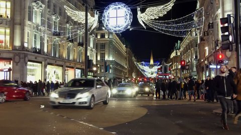 London - DEC 2016: Christmas lights and London buses at the station on busy Oxford Street London, England, United Kingdom in December, 2016. Oxford circus at traffic rush. Includes LTI Black Taxi