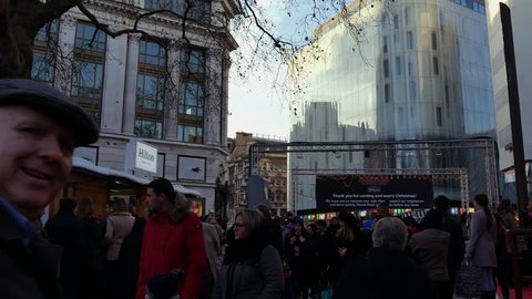 LONDON, UK. December 21,. The junction of Charing Cross Road and Cranbourn Street, right opposite Leicester Square. People walk down the street in sunset.ultra hd 4k