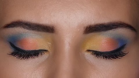 Girl shows beautiful bright make up that made her visagiste . Close up. Slow motion