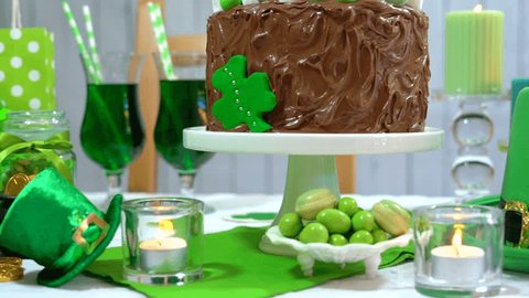Happy St Patricks Day party table with chocolate cake, close up dolly pan. 