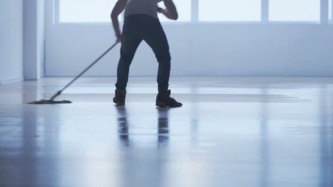 Man Cleaning the Floor in an Exercise Gym