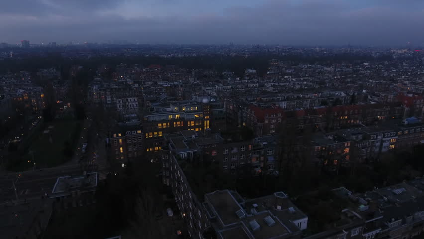 Cloudy city of Amsterdam in evening, aerial of neigborhood in the south.