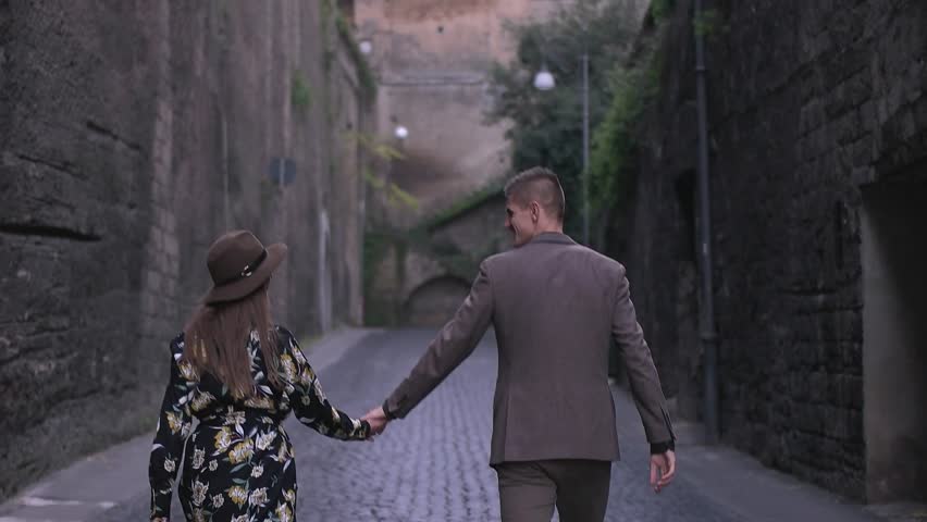 couple walking on the pavement street.