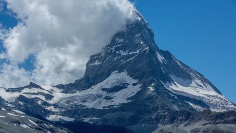 zooming timelapse of the amazing matterhorn and surrounding mountains in the Swiss Alps with fantastic cloud formations
