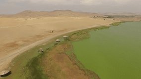 Turquoise lagoon in PERU in desert. AERIAL Video footage of the Lagoon La Encantada in desert near Huacho, Peru