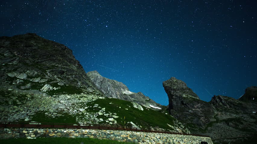 nighttime star time lapse of the Great St Bernard Pass mountains in the Swiss Alps.