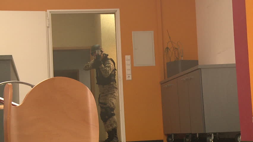Soldier throwing flash grenade into room slow motion