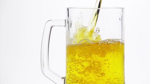 Light Beer is Poured into a Beer Mug on a Light Background. Slow Motion.
