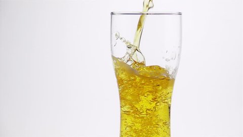 
Light Beer is Poured into the Glass on a Light Background. Slow Motion.
