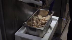 Video of making italian gelatto in kitchen with ice cream machine, selective focus