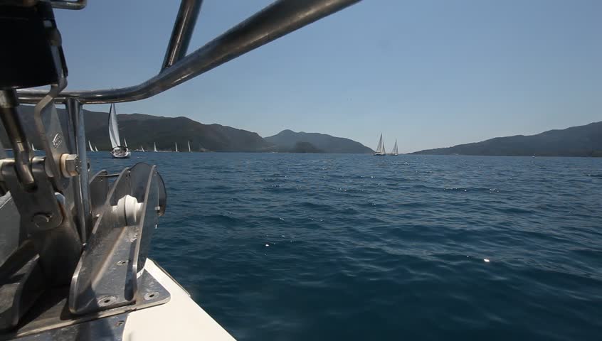 Sailing in the wind through the waves. Sailing boat shot in full HD at the