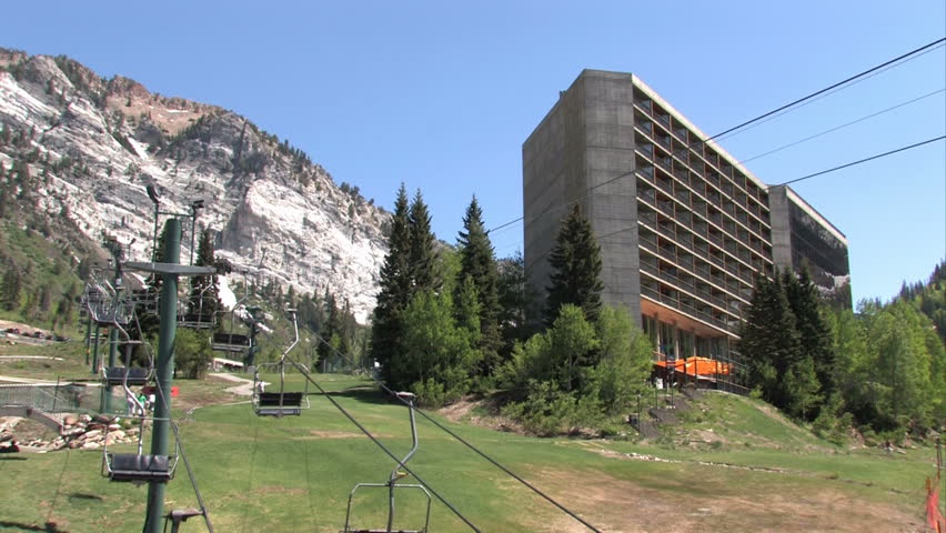 Luxury resorts and timeshare in the high Wasatch Mountain valley of Snowbird Utah.  Summer lift for zip line and recreation. Rugged and high cliffs and forests just outside of Salt lake City, Utah. 