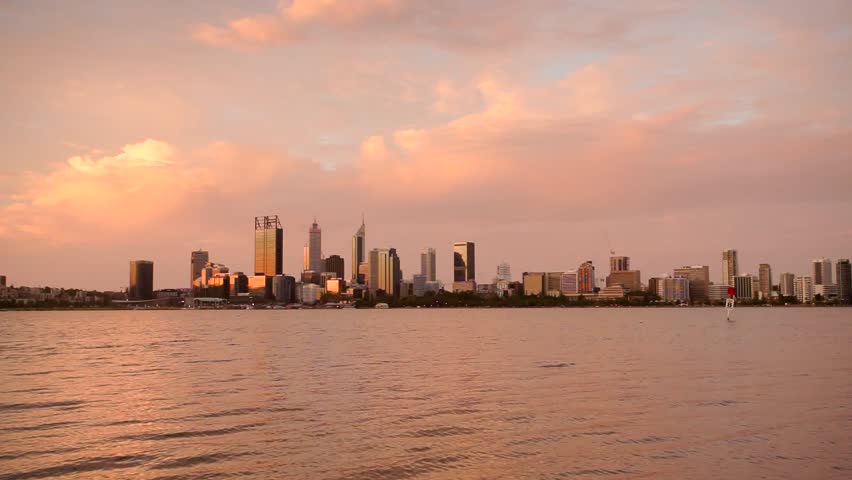 A beautiful red sky during sunset over Perth City with calm waters of the Swan River in the foreground. Western Australia, Australia.