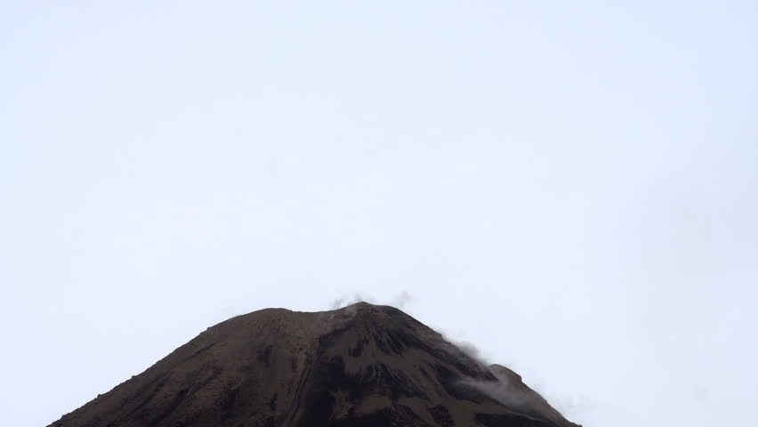 Reventador Volcano erupting at dawn, January 2017. The mountain is situated in a remote part of the Ecuadorian Amazon surrounded by rainforest. Real time.