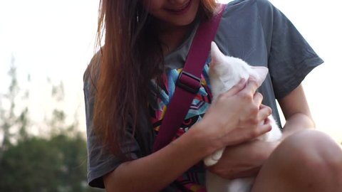 Slow motion : Woman were holding a  white cat on her arm in the morning